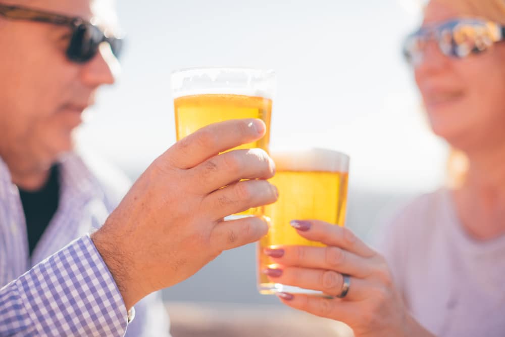 Older couple enjoying a sunny afternoon at one of the top Albuquerque Breweries, like Bow and Arrow Brewing