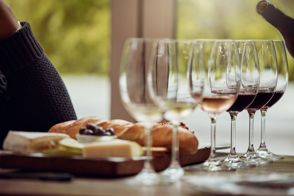 Wine glasses lined up with cheese for tastings at a wine festival in Albuquerque