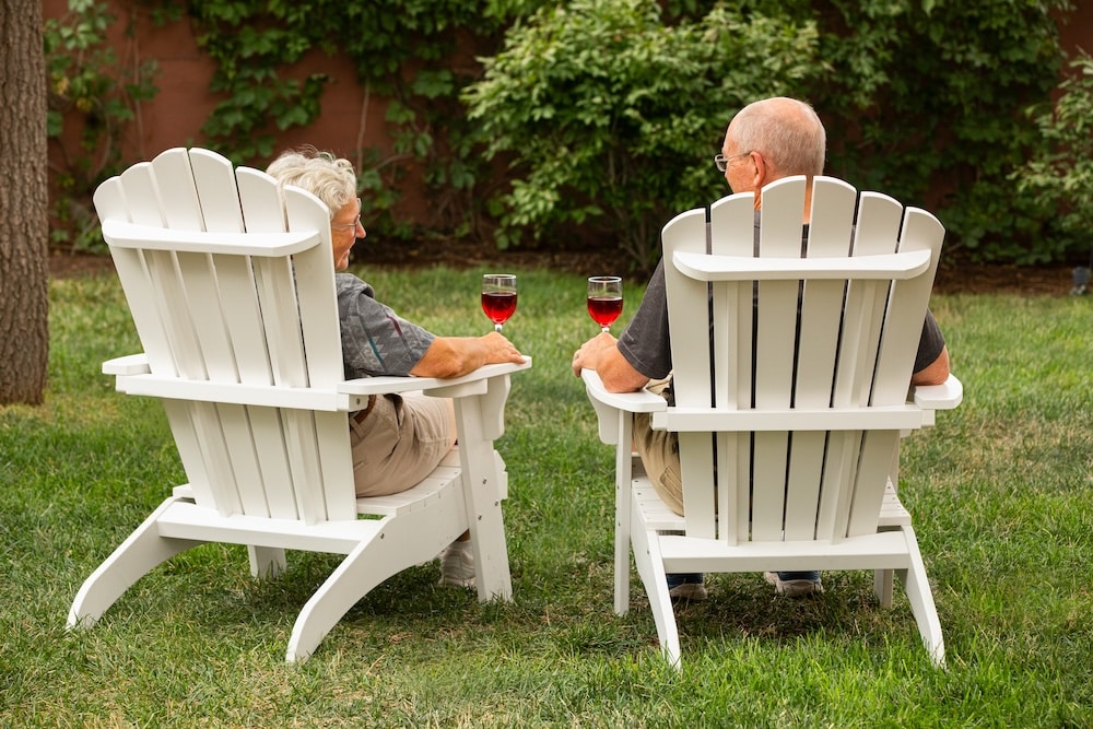 couple sitting outside our Albuquerque Bed and Breakfast with a glass of wine